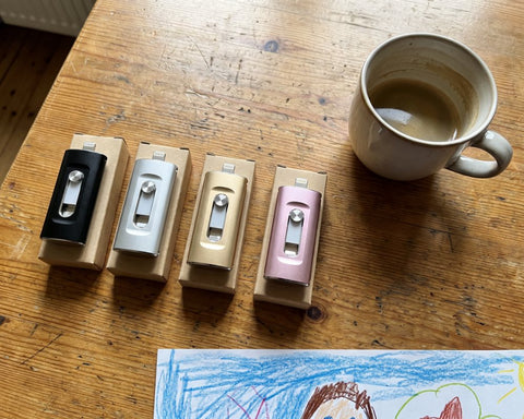 Vier Fotosticks in Schwarz, Silber, Gold und Roségold auf dem Küchentisch